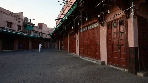 Marrakech, morocco. August 10, 2026. Lone man walking through a deserted narrow Stock Footage 345089834