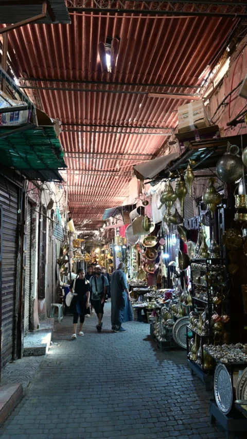 Marrakech, morocco. August 10, 2026. Anonymous people walking along a narrow Stock Footage 345156947