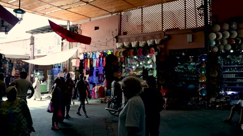 Marrakech, morocco. August 8, 2026. Moroccan flag flying over a busy street Stock Footage 343439812