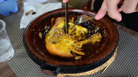Marrakech, morocco. August 8, 2026. A person uses a knife and fork to eat a 스톡 동영상 343714885