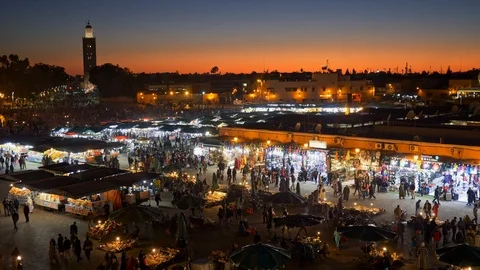 Marrakesh, Morocco. Post sunset evening shot of crowds of people going through Stock Footage 101369739