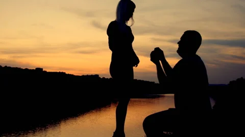 Marriage proposal at sunset. silhouettes Stock Footage