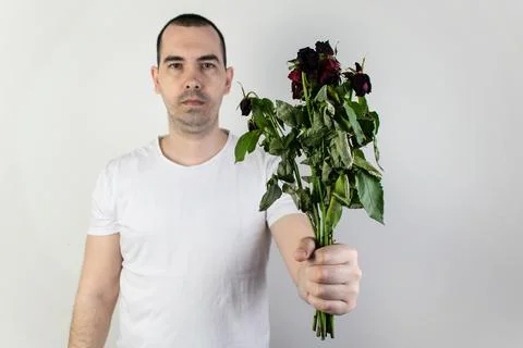 Marridge problems, man hold old dead flowers couples divorce depression rose Stock Photos