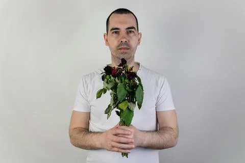 Marridge problems, man hold old dead flowers couples divorce depression rose Stock Photos