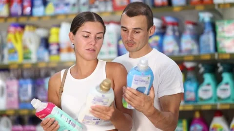 Married couple customer in store chooses package of laundry detergent, Stock Footage 315025271