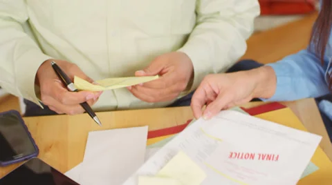 A married couple go over their overdue bills together Stock Footage 34011777