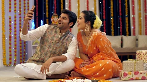 A married couple happily waving and chatting on a video call during Diwali, c... Stock Footage 249245502