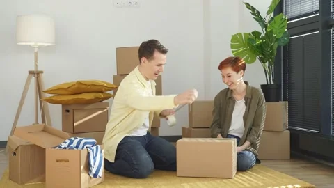 Married couple have fun while preparing personal stuff relocating to first own Video stock 158532297