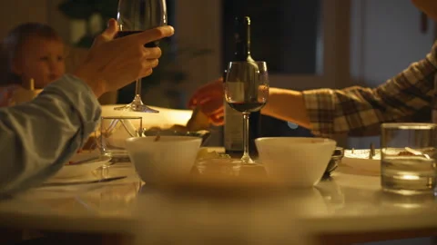 Married couple having dinner sitting at family table in evening. Close up of Stock Footage 297706265
