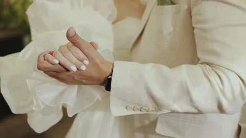 Married couple hold hands. Bride and groom holding hands during the first dance Stock Footage 307919081