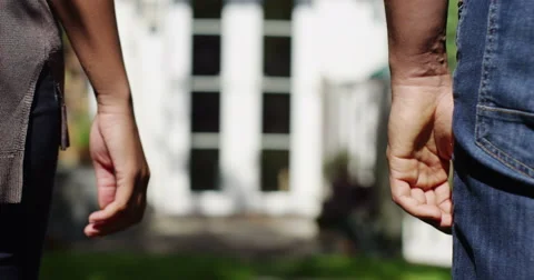 Married couple holding hands in front of their new home. Shot on RED Epic. Video stock 54534820