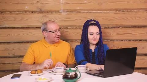 Married couple at home at the table man and woman with afro-haired wife works at Stock Footage 147267338