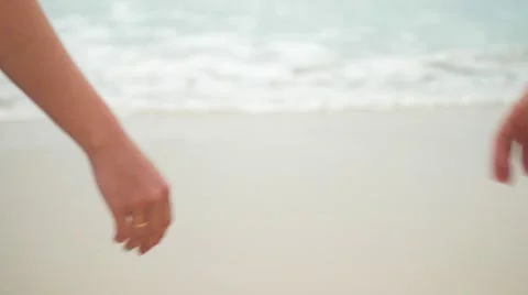 Married couple joining hands and going towards the sea Stock Footage 62612174
