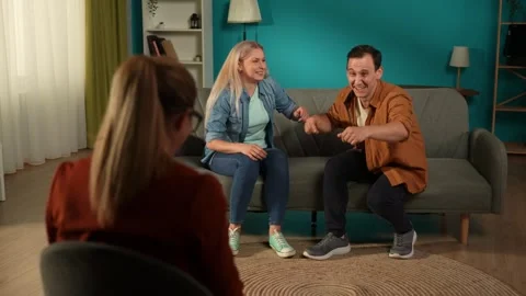 A married couple laughs while recalling funny moments from life at the Video stock 252399832