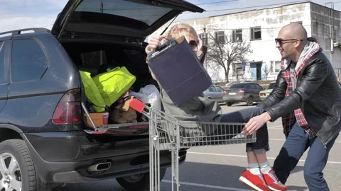 Married couple loading purchases in a car Stock Footage 133522256