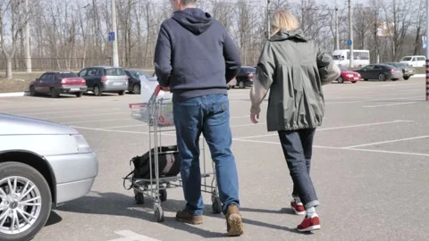 Married couple loading purchases in a car Stock Footage 133523173