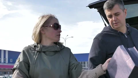 Married couple loading purchases in a car Stock Footage 133524221