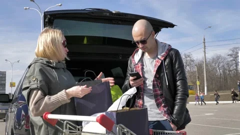 Married couple loading purchases in a car Stock Footage 133524465