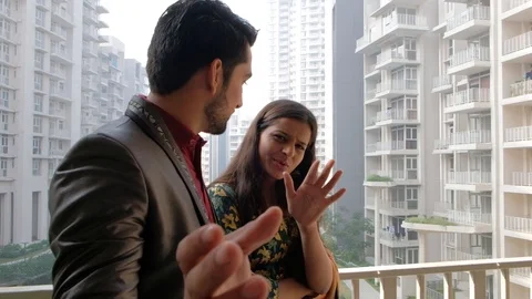 Married couple look at camera and deliberate something as they point the fingers Stock Footage 101335619