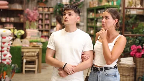 Married couple look for something in room garden furniture store, searching for Stock Footage 341783495