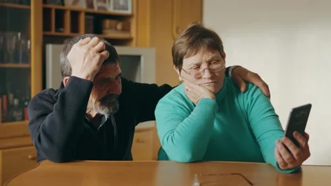 Married couple make video call to relatives using phone and share news Stock Footage 243510933