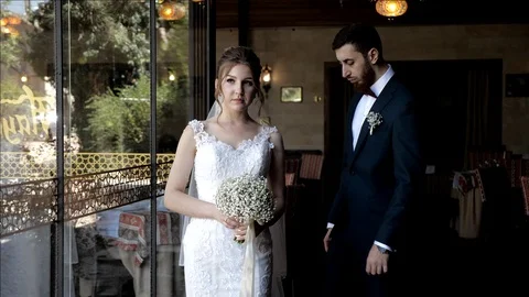 Married couple poses looking ahead at wedding photo shoot Stock Footage 119760936