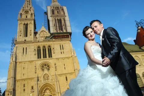 Married couple posing in front of Cathedral Stock Photos