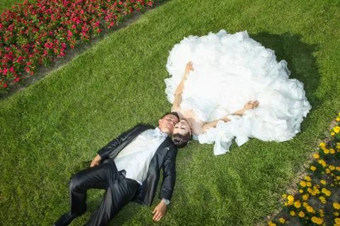 Married couple posing on grass Stock Photos