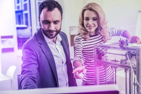 Married couple of programmers feeling excited while watching video at work Stock-Fotos