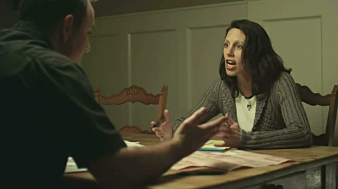 A married couple sit together and argue over their past due bills Video stock 33896901