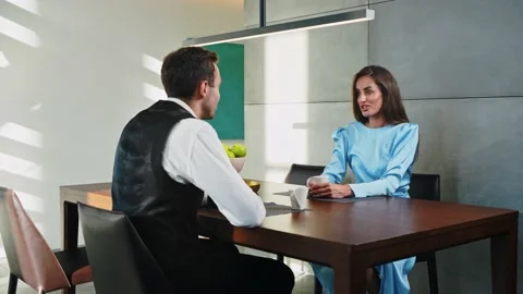 Married couple sitting at the table in the kitchen drinking coffee Stock-Footage 205324770