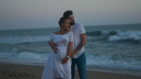 Married couple spend evening together at beach watching amazing sunset Stock Footage 127445650