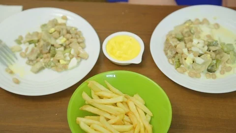 Married couple at the table eating salad and french fries with sauce. Time Laps Stock Footage 125200701