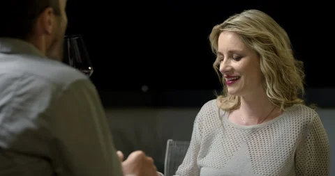 Married Couple Toasting With Glass Of Wine While Chatting Stock Footage 123729465