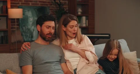 Married Couple using Laptop sitting on couch at home Stock Footage 220624597