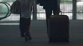 Married couple walking across airport overpass, man carrying suitcase, holidays HD Footage