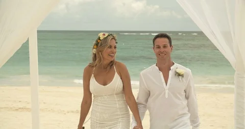 Married Couple Walking Down Aisle After Beach Marriage Ceremony Video stock 112455378