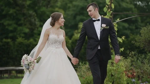 Married couple walking down the park and holding their hands. Stock Footage 103950456