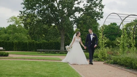 Married couple walking down the park and holding their hands. Stock Footage 103951013