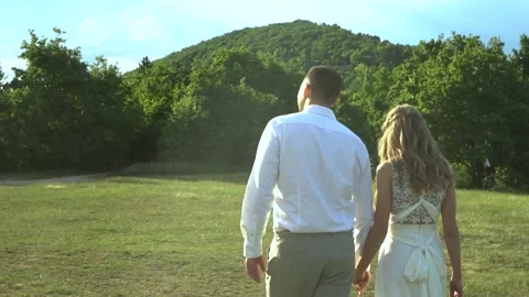 Married couple walking on a field Video stock 232763469