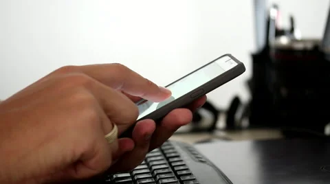 Married man scrolling and typing a text massage on his touchscreen smartphone Video stock 53399629