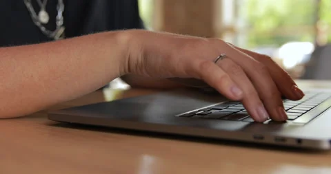 Married woman using laptop computer in hotel lobby, close up of hands typing Stock Footage 135814653