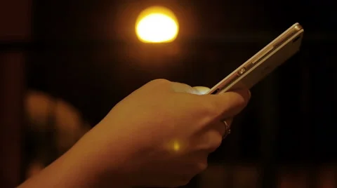  married woman's hand while writing a message with her smartphones at night  Stock Footage 67818127