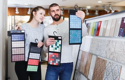 Marrieds standing with sample of ceramic tile Stock Photos