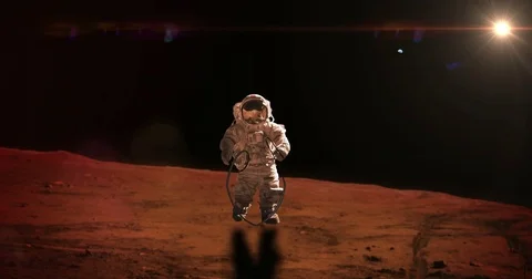 Mars Astronauts Jump Roping on Mars Surface Red Fare Sun, 4K Stock Footage 76900487