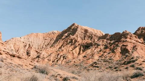 Mars Canyon red sandstone cliffs and arid desert landscape in Kyrgyzstan Stock Photos