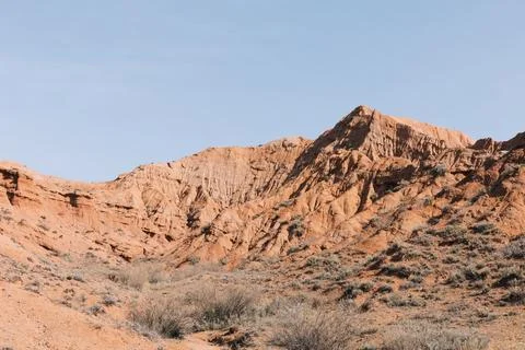 Mars Canyon red sandstone cliffs and arid desert landscape in Kyrgyzstan Stock Photos
