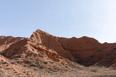 Mars Canyon red sandstone cliffs and arid badlands landscape under clear sky Stock Photos
