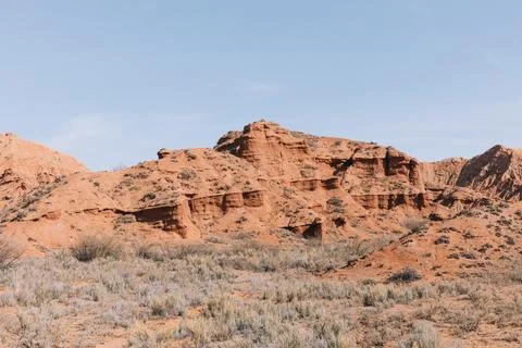 Mars Canyon red sandstone cliffs and semi-desert landscape in Kyrgyzstan Stock Photos