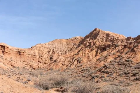 Mars Canyon red sandstone cliffs and arid desert landscape under blue sky Stock Photos
